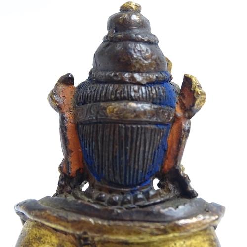 135 - A small Tibetan patinated bronze Jambhala, H9cm