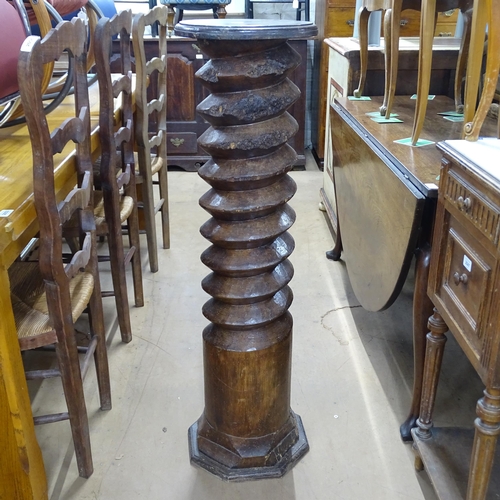 2063 - A French elm spiral turned column with circular top, on octagonal base. 30 x 110cm.