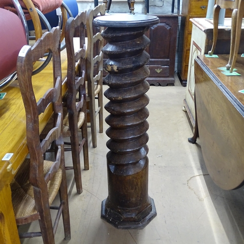 2063 - A French elm spiral turned column with circular top, on octagonal base. 30 x 110cm.