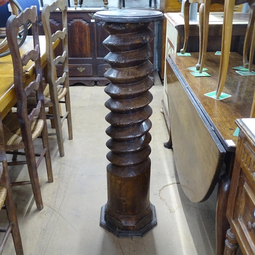 2063 - A French elm spiral turned column with circular top, on octagonal base. 30 x 110cm.