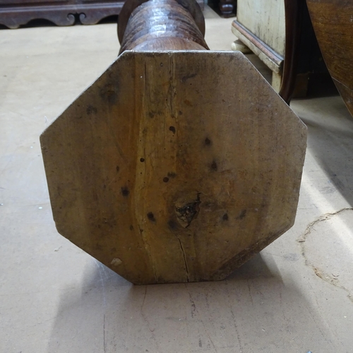 2063 - A French elm spiral turned column with circular top, on octagonal base. 30 x 110cm.