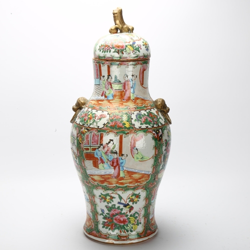 23 - A Chinese Canton famille rose vase and cover, with hand painted and enamelled figures in courtyard a... 