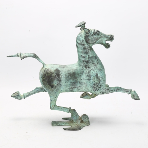 106 - A Tang style hollow bronze patinated horse, height 25cm