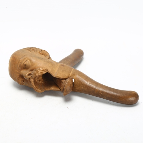 117 - An early 20th century carved fruitwood nutcracker in the form of Otto Von Bismarck, length 20cm