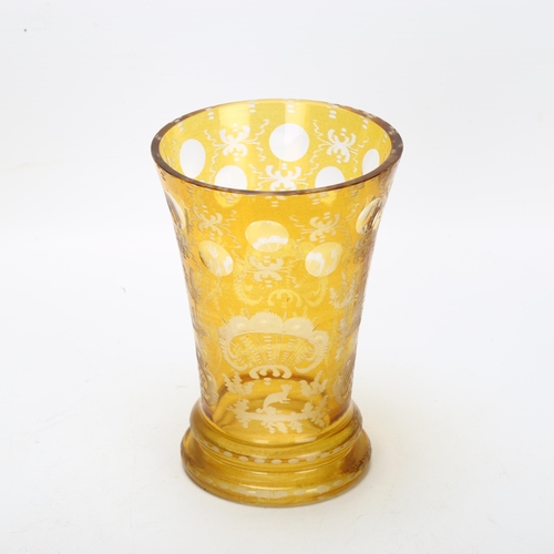 122 - A 19th century Bohemian amber-flashed glass spa beaker, with etched stag and bridge decoration, heig... 