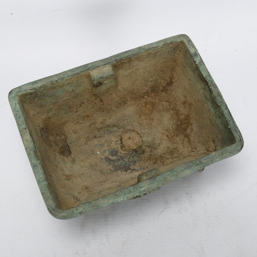 33 - A Chinese verdigris bronze Archaic style 'Dragon' censer, with relief decoration and character marks... 