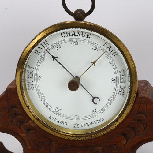 38 - A brass-cased aneroid barometer, maker's mark SJL & Co, on fitted Gothic oak base, width 22cm