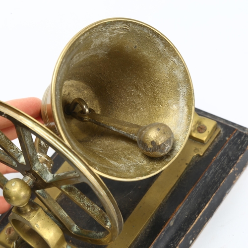 41 - A novelty cast-brass desk bell, on ebonised base, width 18cm