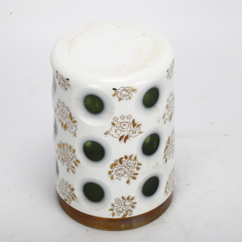 71 - A 19th century Bohemian green flashed white glass cylinder jar, with circular cut apertures and gild... 