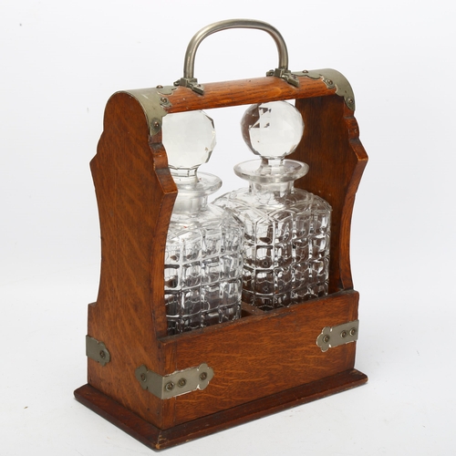 78 - An oak 2-bottle tantalus, with square section decanters, no key, W23cm, D13cm, H31cm