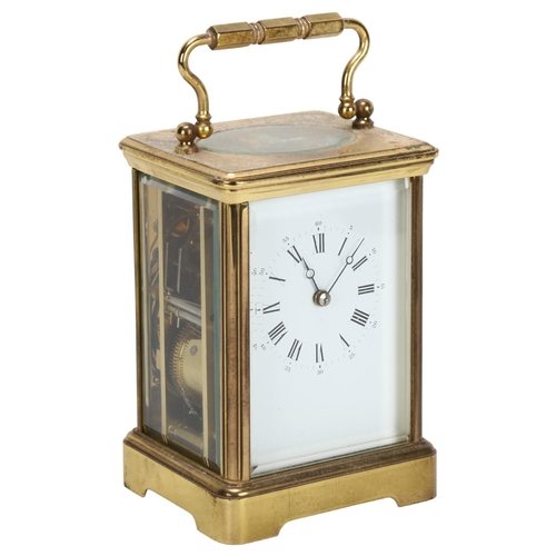 87 - A brass-cased carriage clock, with white dial and Roman numeral hour markers, with movement striking... 