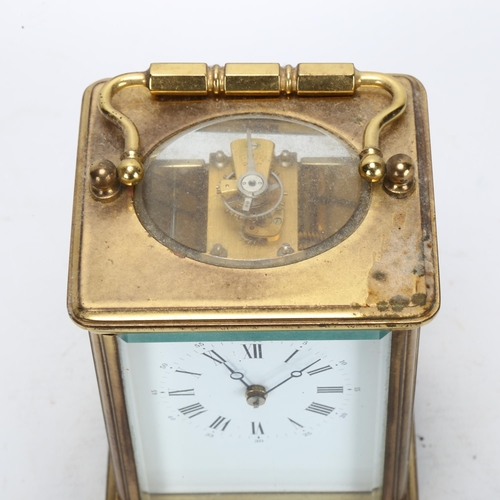 87 - A brass-cased carriage clock, with white dial and Roman numeral hour markers, with movement striking... 