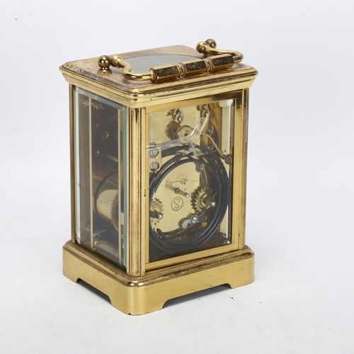 87 - A brass-cased carriage clock, with white dial and Roman numeral hour markers, with movement striking... 