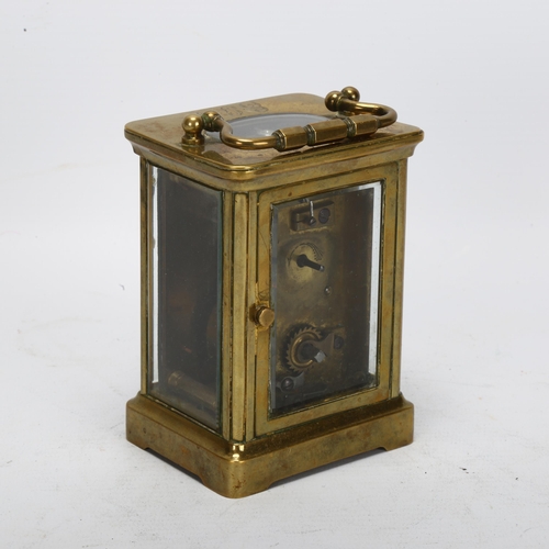 92 - A 19th century brass-cased carriage clock, white enamel dial with Roman numeral hour markers, case h... 