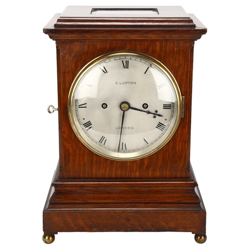 174 - An early 20th century oak-cased 8-day table clock, by Clifford Lupton of London, with bevelled glass... 