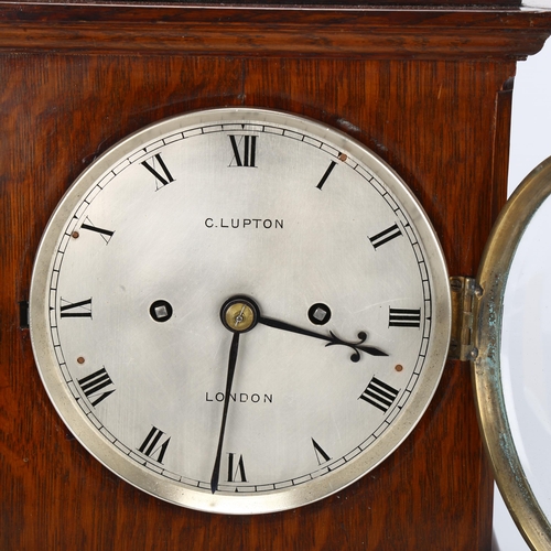 174 - An early 20th century oak-cased 8-day table clock, by Clifford Lupton of London, with bevelled glass... 