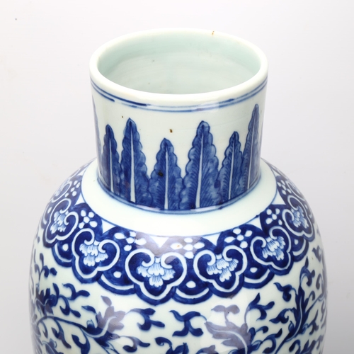 198 - A large Chinese blue and white baluster vase with floral decoration, on wooden stand, height of vase... 