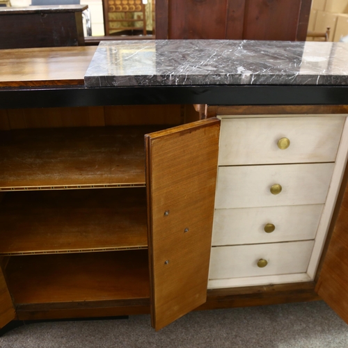 262 - A large Art Deco walnut sideboard, in Bauhaus style, with ebonised sides and plinth and marble centr... 