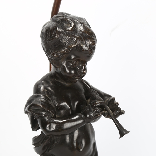 269 - An Antique bronze cherub sculpture playing pipes, on marble base with lamp fitting, bronze height 37... 