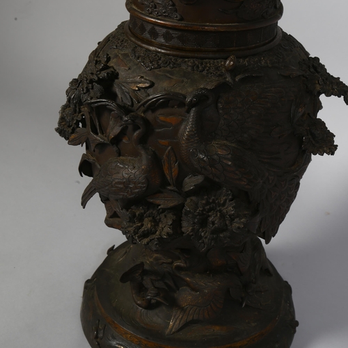 277 - An Antique Chinese large cast-bronze vase in 2 sections, with birds and plants in high relief, heigh... 