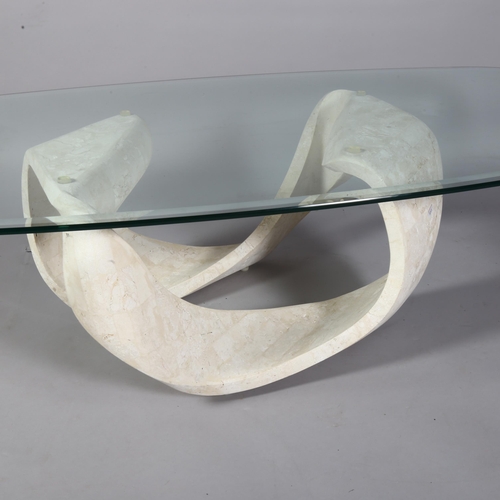 519 - A contemporary coffee table with tessellated limestone sculptural loop base and bevelled glass top, ... 