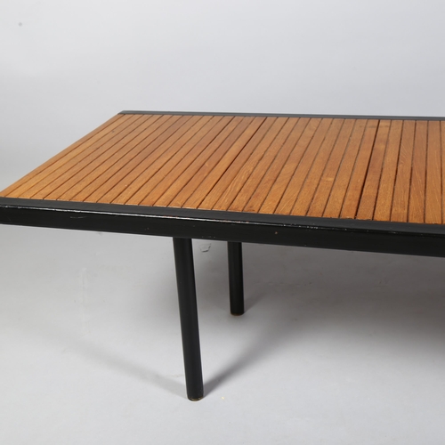 522 - A mid-century teak and iron coffee table, of teak block construction bound with iron edging, British... 