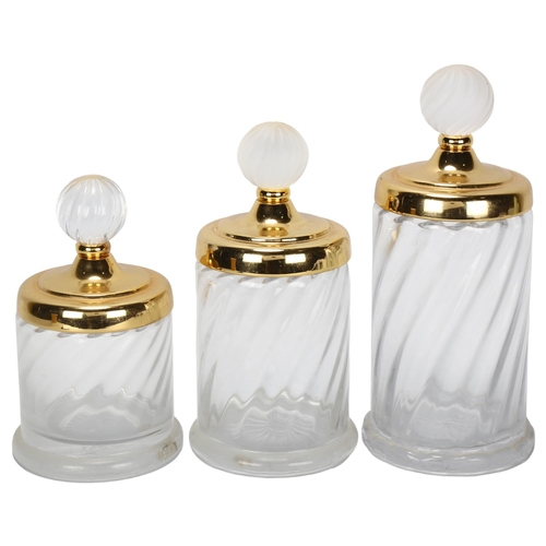 406 - A graduated set of 3 Hollywood Regency style glass cylinder jars, with gilded metal lid and frosted ... 