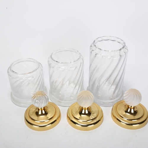 406 - A graduated set of 3 Hollywood Regency style glass cylinder jars, with gilded metal lid and frosted ... 