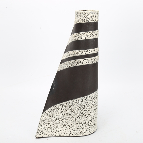 464 - Keith Booth, studio pottery sail form vase, volcanic glaze on basalt, signed to base, height 31cm