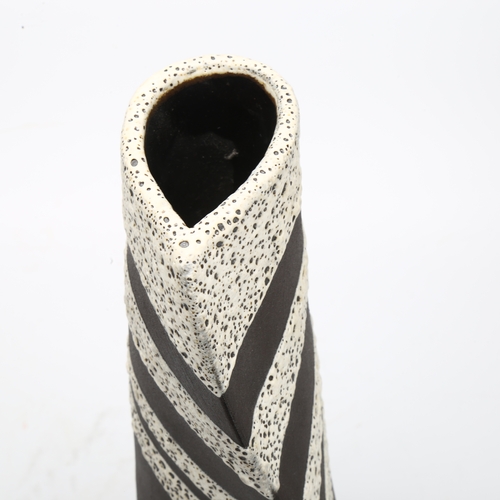 464 - Keith Booth, studio pottery sail form vase, volcanic glaze on basalt, signed to base, height 31cm