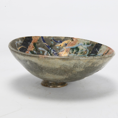 524 - A mid-century footed studio pottery centre bowl, with combed exterior and splash glaze interior, mak... 