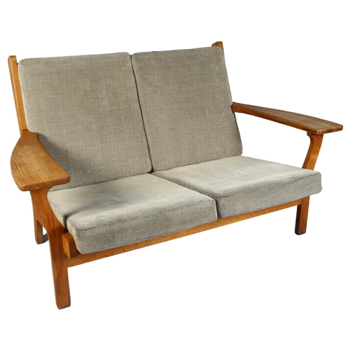 451 - Hans Wegner, a mid-century Danish 2-seater sofa, model GE 330/2  by Getama, the oak frame with inter... 