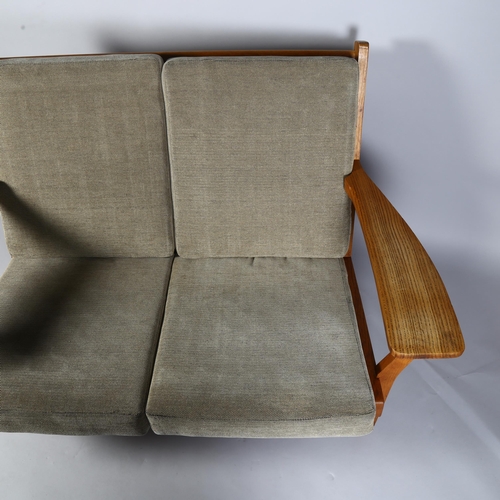 451 - Hans Wegner, a mid-century Danish 2-seater sofa, model GE 330/2  by Getama, the oak frame with inter... 