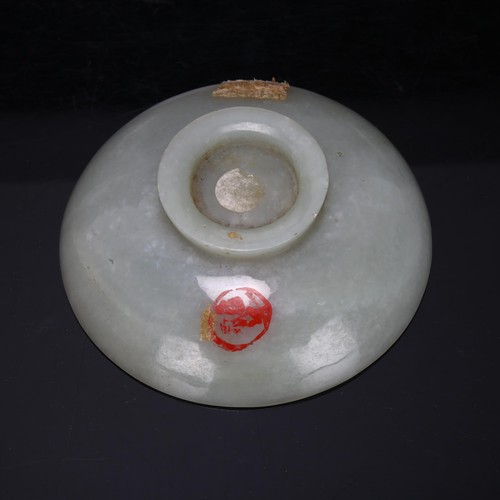 178 - A Chinese jade carved footed bowl, with paint seal to underside, diameter 10cm