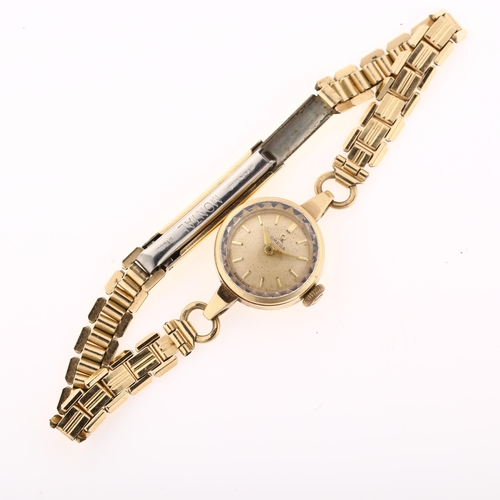 1032 - OMEGA - a lady's 9ct gold mechanical bracelet watch, ref. 66803, circa 1959, silvered dial with gilt... 