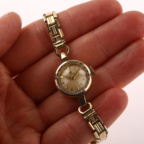 1032 - OMEGA - a lady's 9ct gold mechanical bracelet watch, ref. 66803, circa 1959, silvered dial with gilt... 