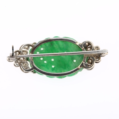 1103 - An Art Deco jade and diamond brooch, circa 1930, unmarked white metal settings with carved and pierc... 