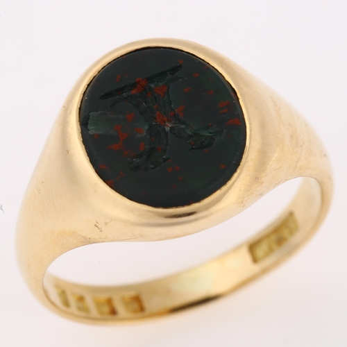 1144 - An early 20th century 18ct gold bloodstone 'Double Headed Eagle', seal signet ring, set with oval in... 