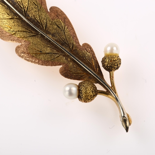 1148 - An early 20th century 18ct and 15ct gold and pearl acorn and oak leaf brooch, realistically modelled... 