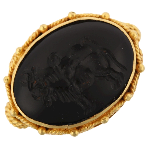 1278 - A Victorian style seal ring, unmarked yellow metal settings with wirework surround and intaglio carv... 