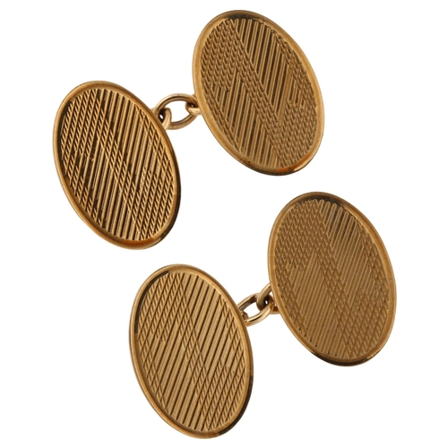 1153 - A pair of Art Deco 9ct gold cufflinks, oval panels with engine turned decoration, maker's marks EAP,... 