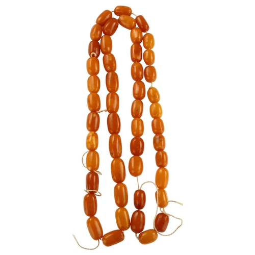 1155 - A single-strand butterscotch amber barrel bead necklace, bead lengths ranging from 227.4 - 15.6mm, n... 