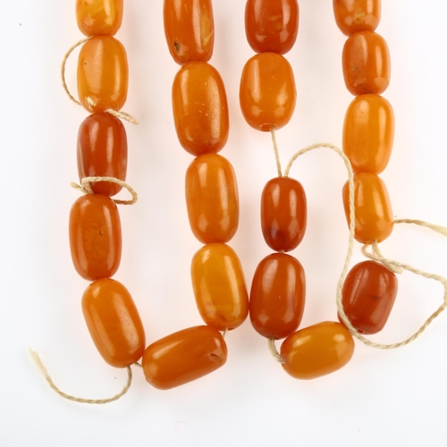 1155 - A single-strand butterscotch amber barrel bead necklace, bead lengths ranging from 227.4 - 15.6mm, n... 