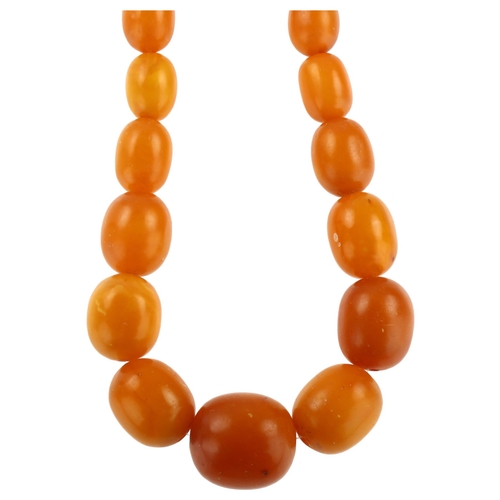 1156 - A graduated single-strand butterscotch amber bead necklace, with 9ct rose gold clasp, bead lengths r... 