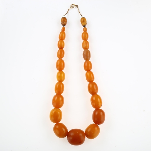 1156 - A graduated single-strand butterscotch amber bead necklace, with 9ct rose gold clasp, bead lengths r... 