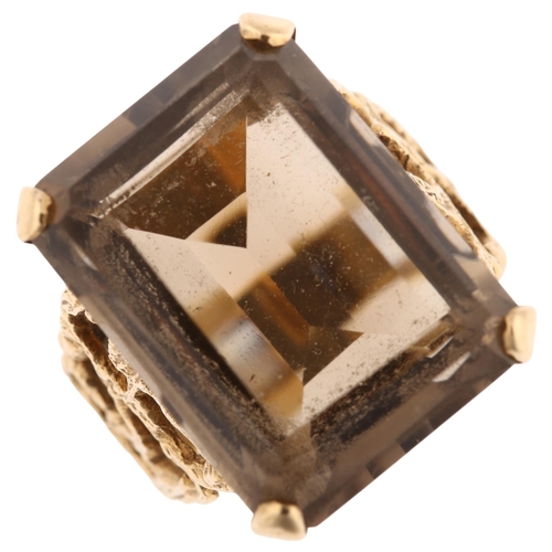 1167 - A large 1970s smoky quartz dress ring, unmarked 9ct gold settings with pierced and textured bark des... 