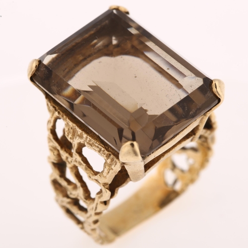 1167 - A large 1970s smoky quartz dress ring, unmarked 9ct gold settings with pierced and textured bark des... 