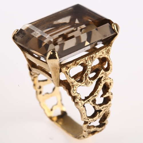 1167 - A large 1970s smoky quartz dress ring, unmarked 9ct gold settings with pierced and textured bark des... 