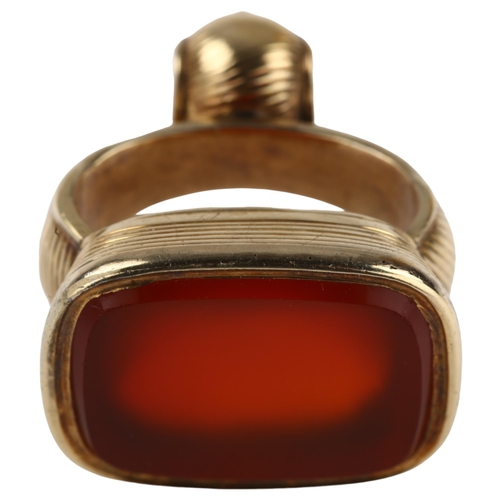 1168 - A 19th century carnelian fob, unmarked yellow metal ribbed frame with blank inset carnelian, carneli... 