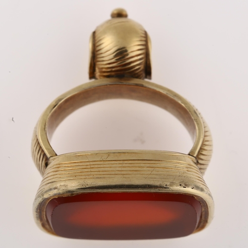 1168 - A 19th century carnelian fob, unmarked yellow metal ribbed frame with blank inset carnelian, carneli... 